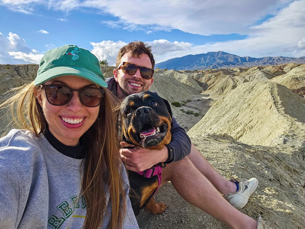 Couple hiking with Rottweiler in Anza-Borrego badlands California