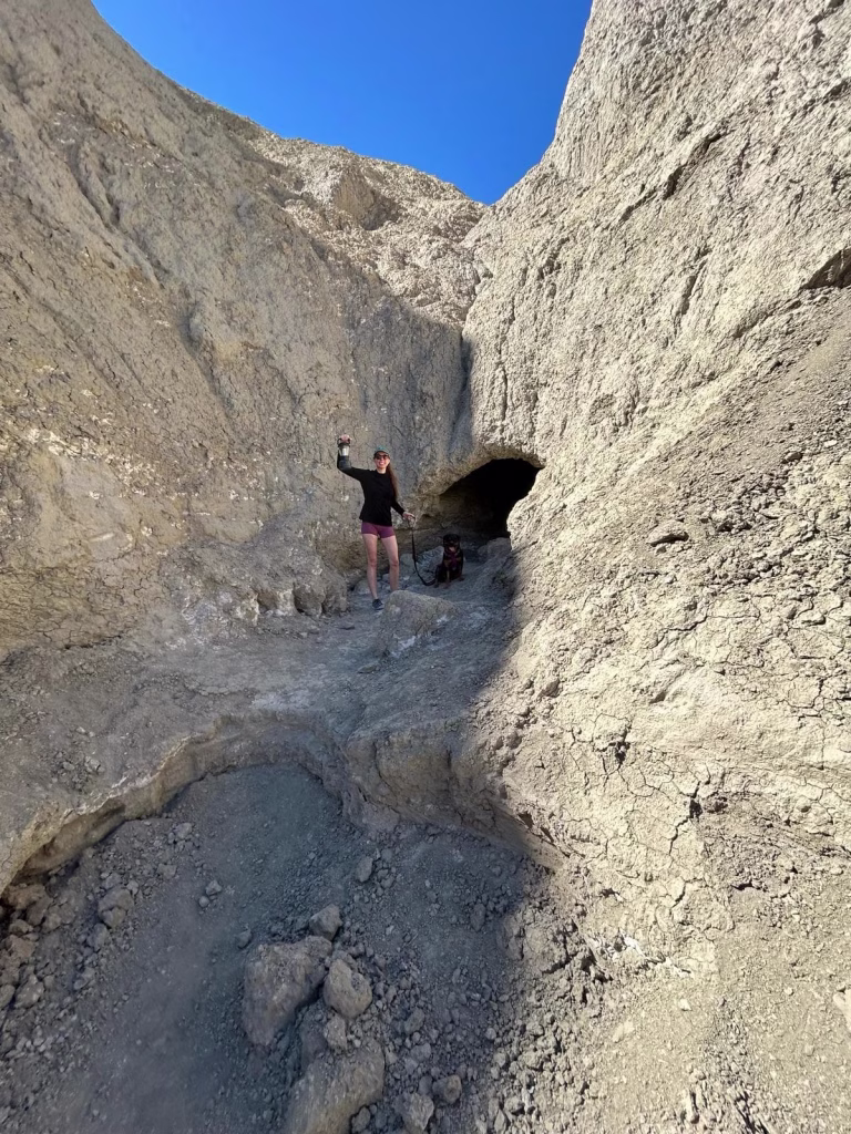 Wild Mud Cave entrance in Anza-Borrego Desert State Park with hiker and dog