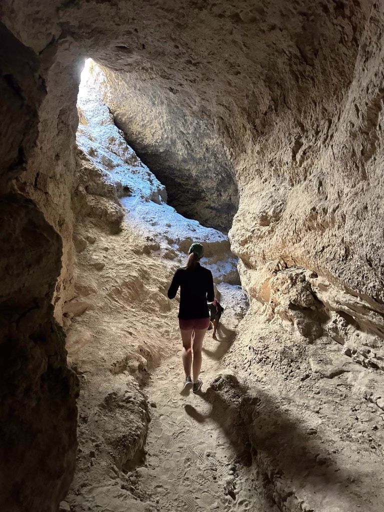 Hiking through narrow slot canyon at Wild Mud Cave Anza-Borrego